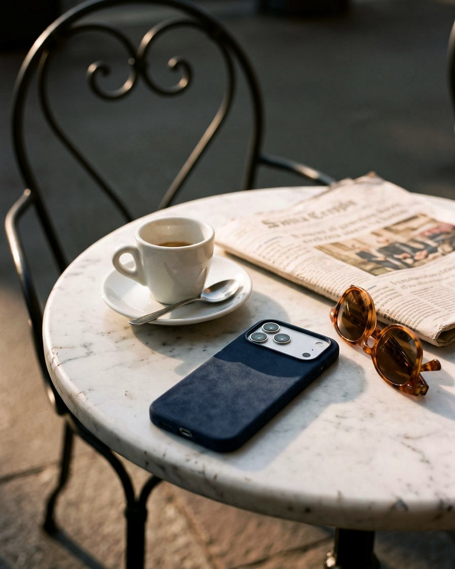 Navy Velluto Case at a café table in Milan
